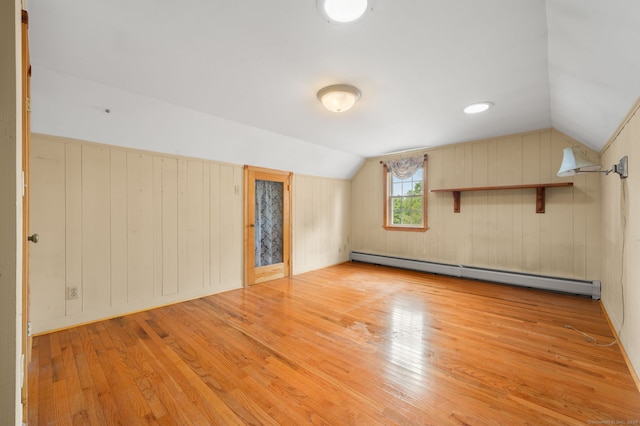 717 Center St, Manchester, CT 06040 - bonus room featuring a baseboard radiator, light wood-style floors, vaulted ceiling, and wooden walls
