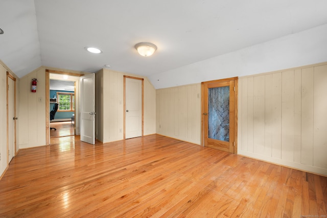 717 Center St, Manchester, CT 06040 - unfurnished bedroom featuring light wood-style floors, vaulted ceiling, and wooden walls