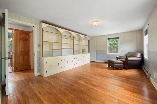717 Center St, Manchester, CT 06040 - sitting room featuring wallpapered walls, a baseboard radiator, hardwood / wood-style flooring, and baseboards