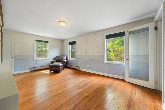 717 Center St, Manchester, CT 06040 - sitting room with wallpapered walls, a baseboard radiator, hardwood / wood-style floors, and baseboards
