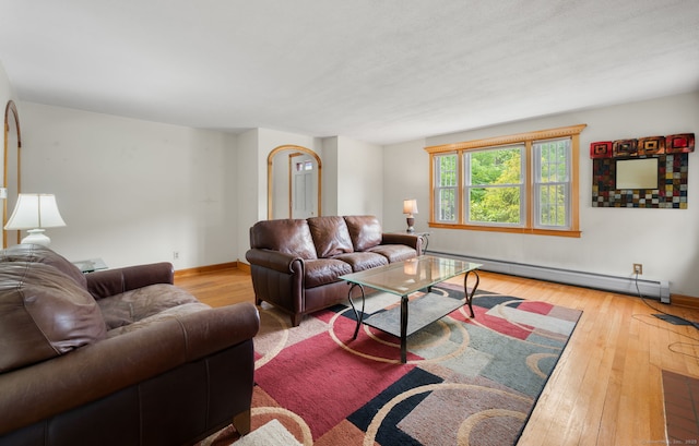 717 Center St, Manchester, CT 06040 - living area with baseboard heating, hardwood / wood-style floors, and baseboards