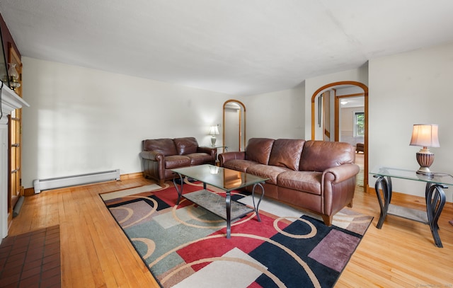 717 Center St, Manchester, CT 06040 - living room featuring baseboard heating, arched walkways, and hardwood / wood-style flooring