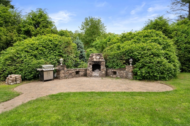 717 Center St, Manchester, CT 06040 - view of grassy yard featuring an outdoor stone fireplace and a patio area