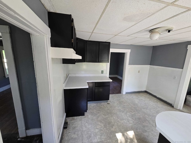 827 Middle Tpke E, Manchester, CT 06040 - kitchen with dark cabinets, a drop ceiling, baseboards, and light countertops