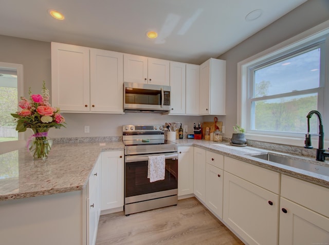 1026 Rte 171, Woodstock, CT 06281 - kitchen with stainless steel appliances, a sink, healthy amount of natural light, white cabinetry, and recessed lighting