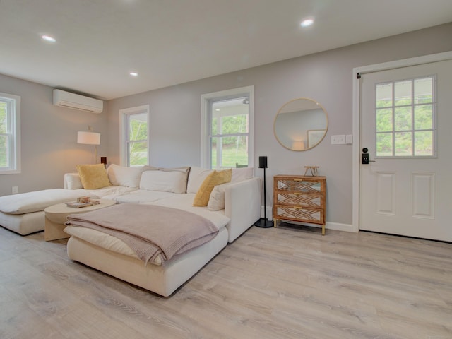 1026 Rte 171, Woodstock, CT 06281 - living area featuring an AC wall unit, light wood finished floors, healthy amount of natural light, and recessed lighting
