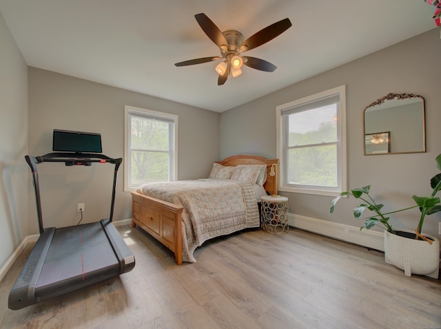 1026 Rte 171, Woodstock, CT 06281 - bedroom featuring a baseboard heating unit, light wood-style flooring, and baseboards