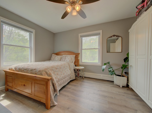 1026 Rte 171, Woodstock, CT 06281 - bedroom with multiple windows, a baseboard radiator, light wood-style floors, and baseboards
