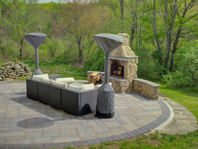 1026 Rte 171, Woodstock, CT 06281 - view of patio with a view of trees and an outdoor living space with a fireplace