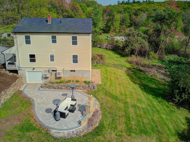 1026 Rte 171, Woodstock, CT 06281 - rear view of house featuring an attached garage, a chimney, a lawn, a view of trees, and a shingled roof