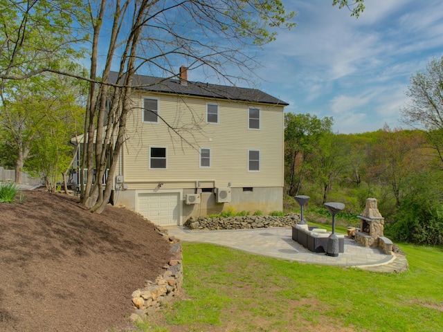 1026 Rte 171, Woodstock, CT 06281 - rear view of house with an attached garage, a chimney, driveway, a lawn, and a patio area