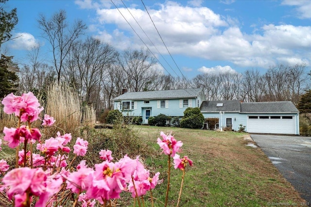31 Branch Hill Rd, Preston, CT 06365 - view of front of house featuring a garage, asphalt driveway, a front yard, and a chimney