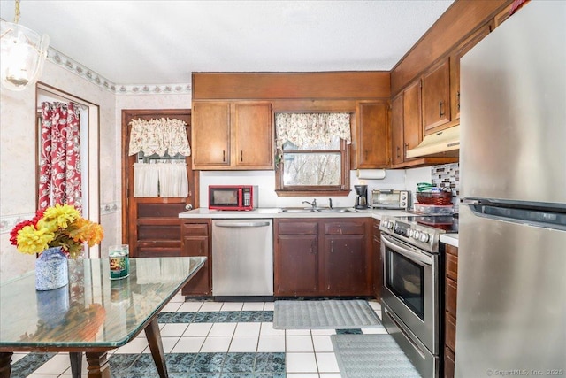 31 Branch Hill Rd, Preston, CT 06365 - kitchen with stainless steel appliances, a sink, light countertops, light tile patterned flooring, and under cabinet range hood
