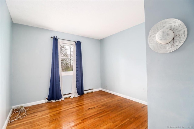 31 Branch Hill Rd, Preston, CT 06365 - empty room with wood finished floors, baseboards, and a baseboard radiator