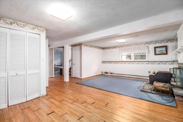 31 Branch Hill Rd, Preston, CT 06365 - workout area featuring light wood-type flooring, a textured ceiling, and a baseboard radiator