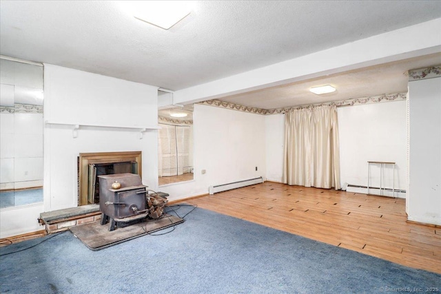 31 Branch Hill Rd, Preston, CT 06365 - unfurnished living room with a baseboard radiator, a wood stove, and wood finished floors