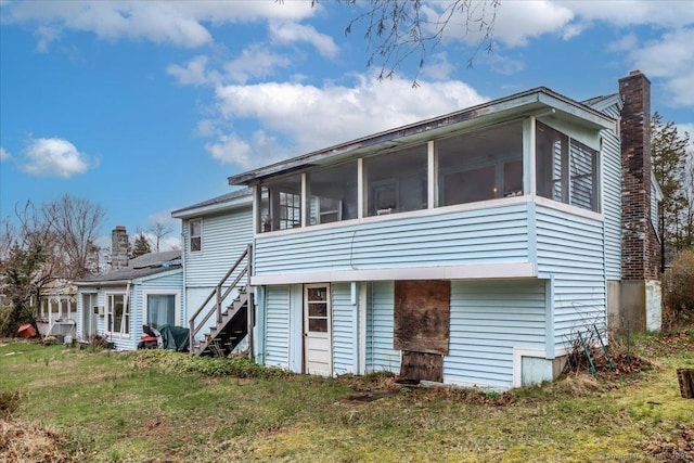31 Branch Hill Rd, Preston, CT 06365 - rear view of property featuring a sunroom, a chimney, a lawn, and stairway