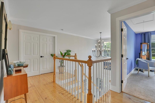 100 Round Hill Rd, Middletown, CT 06457 - hall with attic access, an upstairs landing, light wood-type flooring, a chandelier, and crown molding