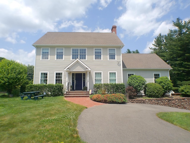 100 Round Hill Rd, Middletown, CT 06457 - colonial-style house featuring a chimney, a front lawn, and a shingled roof