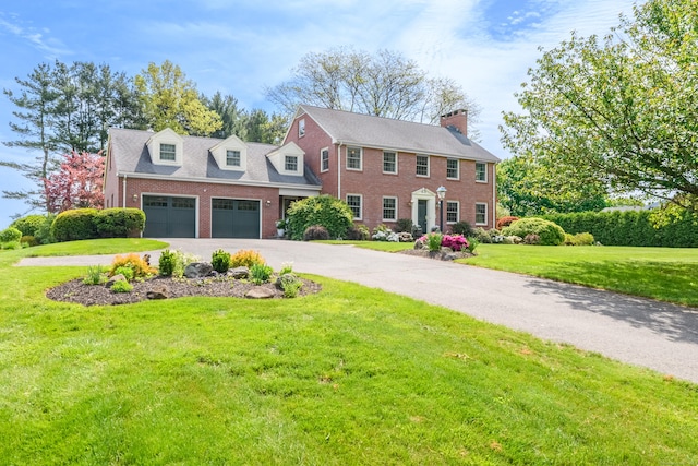 116 Thornbush Rd, Wethersfield, CT 06109 - colonial inspired home featuring brick siding, asphalt driveway, a garage, a front yard, and a chimney