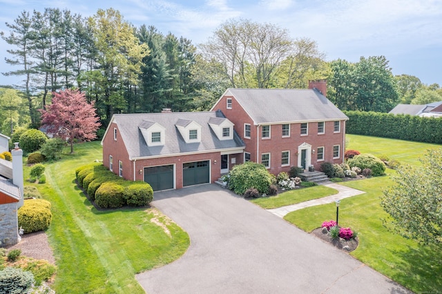 116 Thornbush Rd, Wethersfield, CT 06109 - view of front of property with brick siding, a chimney, driveway, and a front yard