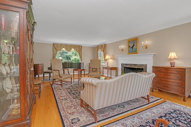 116 Thornbush Rd, Wethersfield, CT 06109 - living area featuring light wood finished floors, a premium fireplace, and ornamental molding