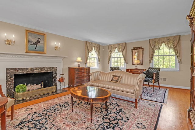 116 Thornbush Rd, Wethersfield, CT 06109 - living room with wood finished floors, a fireplace, crown molding, and baseboards