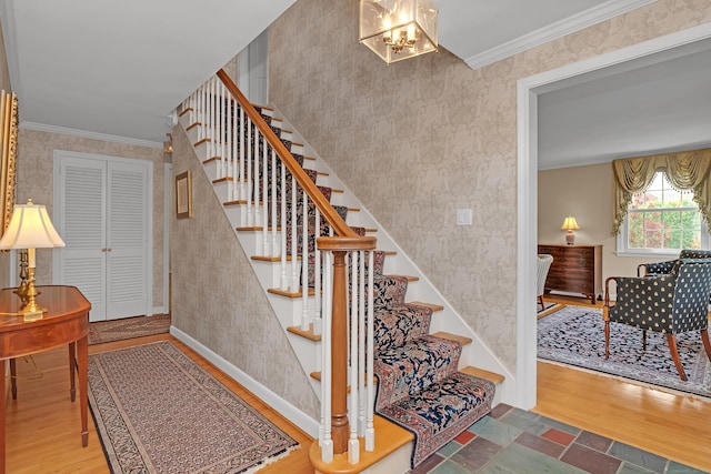 116 Thornbush Rd, Wethersfield, CT 06109 - stairway featuring wallpapered walls, wood finished floors, crown molding, a chandelier, and baseboards