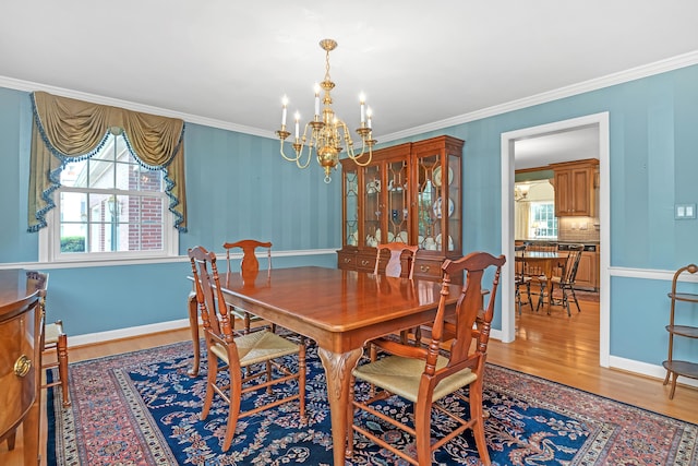 116 Thornbush Rd, Wethersfield, CT 06109 - dining area with a chandelier, wood finished floors, ornamental molding, and baseboards