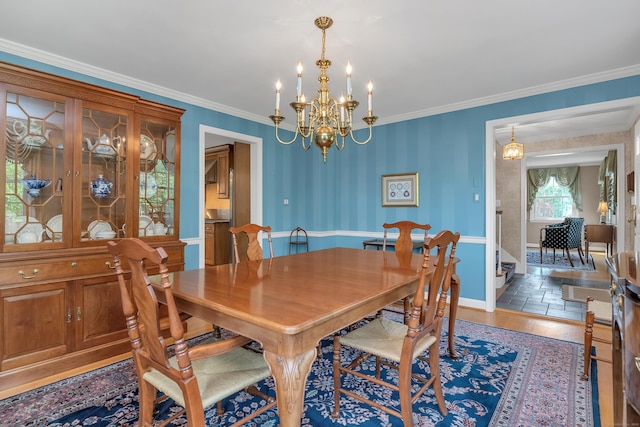 116 Thornbush Rd, Wethersfield, CT 06109 - dining space featuring a chandelier, ornamental molding, wood finished floors, and baseboards