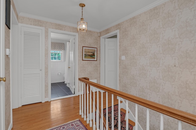 116 Thornbush Rd, Wethersfield, CT 06109 - corridor with light wood-type flooring, an upstairs landing, wallpapered walls, and crown molding