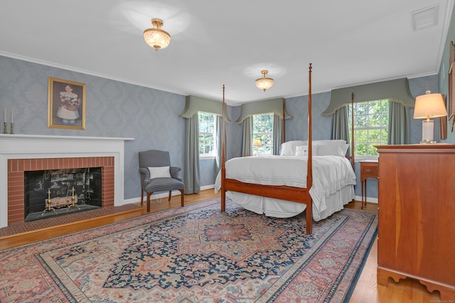 116 Thornbush Rd, Wethersfield, CT 06109 - bedroom with wood finished floors, multiple windows, ornamental molding, wallpapered walls, and a brick fireplace