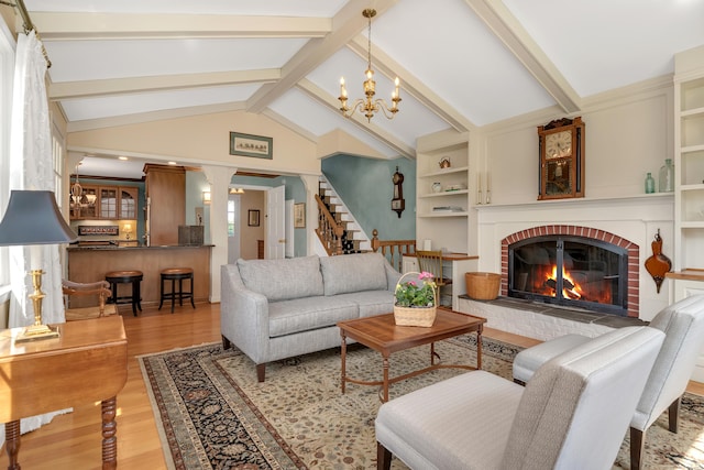 116 Thornbush Rd, Wethersfield, CT 06109 - living room with wood finished floors, a fireplace, a chandelier, and stairway