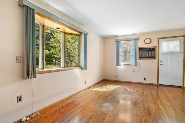 1 Cedar Rd, Danbury, CT 06811 - spare room with wood finished floors, a wall unit AC, and baseboards