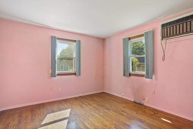1 Cedar Rd, Danbury, CT 06811 - spare room featuring wood finished floors, baseboards, and a wall unit AC