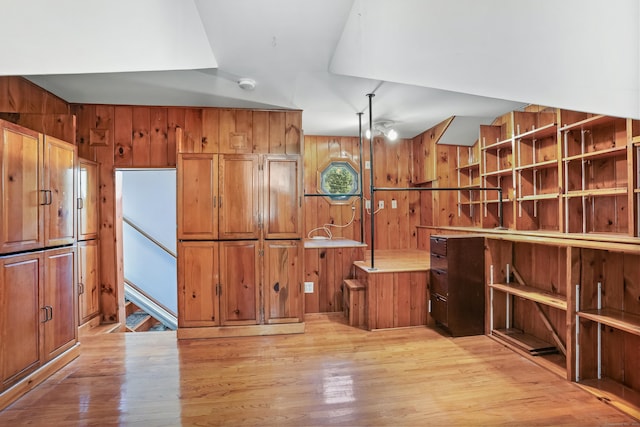 1 Cedar Rd, Danbury, CT 06811 - kitchen with brown cabinetry, light wood finished floors, wood walls, and light countertops