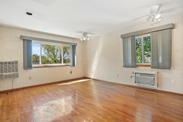1 Cedar Rd, Danbury, CT 06811 - unfurnished living room featuring ceiling fan, wood finished floors, wallpapered walls, a wall mounted AC, and baseboards