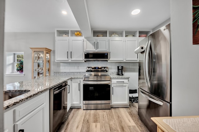 3 Lynns Corner Rd, Woodbury, CT 06798 - kitchen with appliances with stainless steel finishes, light wood-style floors, white cabinets, and light stone counters