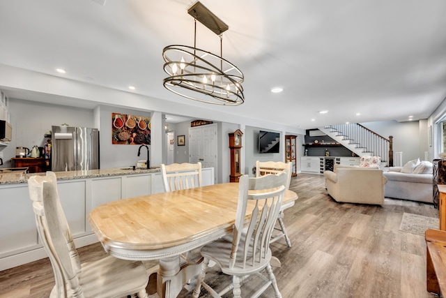 3 Lynns Corner Rd, Woodbury, CT 06798 - dining room with stairs, light wood-style flooring, a chandelier, recessed lighting, and bar area