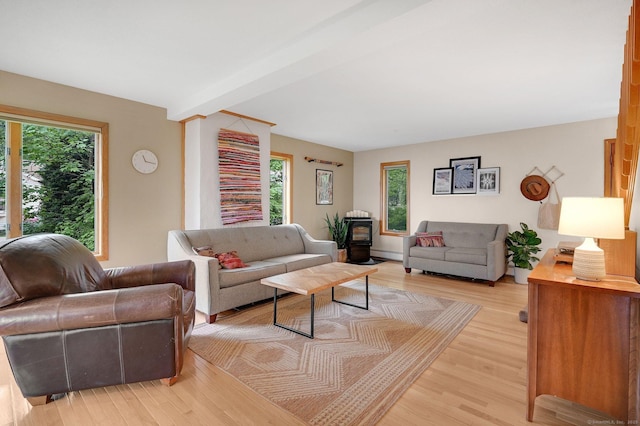 33 Erdoni Rd, Columbia, CT 06237 - living area with healthy amount of natural light, light wood-style flooring, a wood stove, and baseboard heating