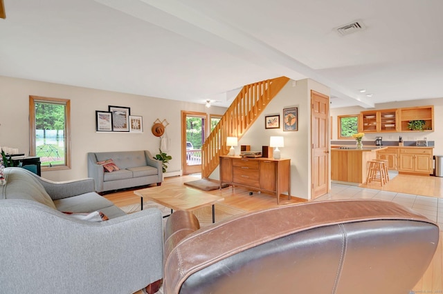 33 Erdoni Rd, Columbia, CT 06237 - living room with stairs, healthy amount of natural light, wet bar, and baseboards