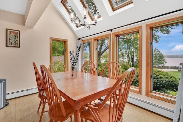 33 Erdoni Rd, Columbia, CT 06237 - dining area featuring baseboard heating, light wood finished floors, a skylight, vaulted ceiling, and a chandelier