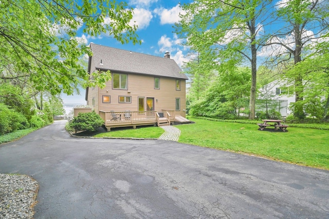 33 Erdoni Rd, Columbia, CT 06237 - rear view of property with a chimney, a wooden deck, a lawn, and roof with shingles