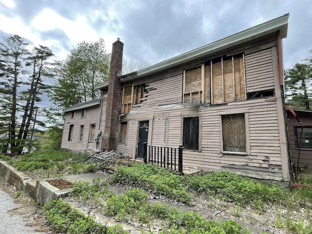 back of property featuring a chimney
