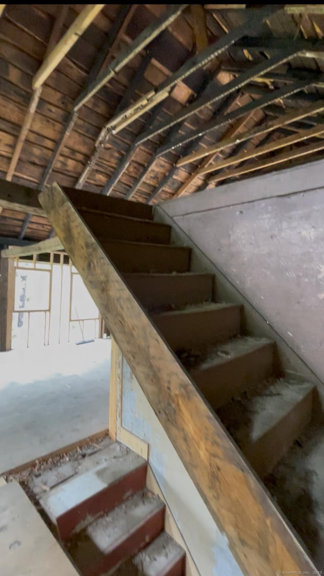 staircase featuring vaulted ceiling