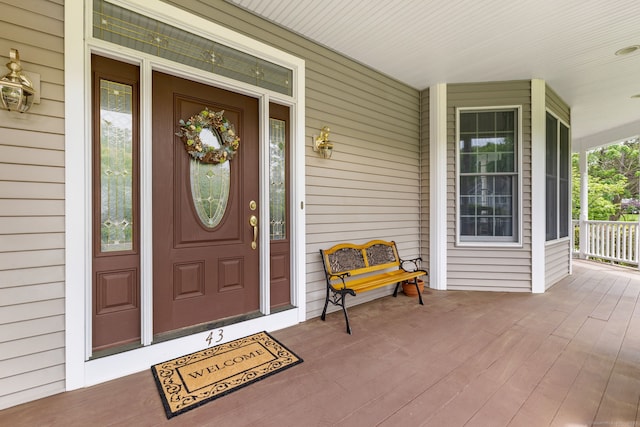 view of exterior entry with covered porch