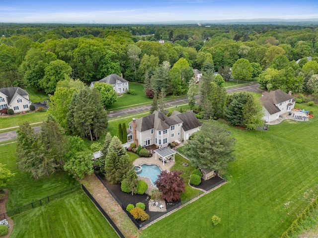 drone / aerial view of a forest and a pool