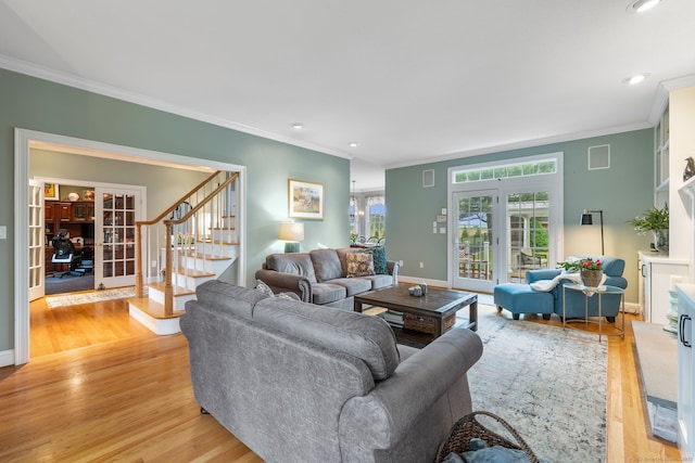living room with crown molding, light wood-type flooring, stairs, recessed lighting, and french doors