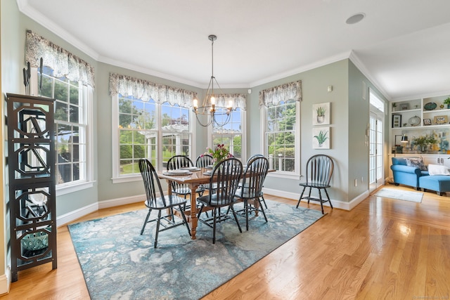 dining area featuring ornamental molding, wood finished floors, a chandelier, and baseboards