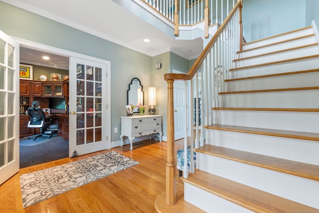 stairs with french doors, ornamental molding, wood finished floors, baseboards, and recessed lighting